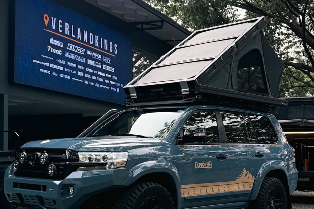 Hard shell rooftop tent installed on an off-road SUV outside an Overland Kings store