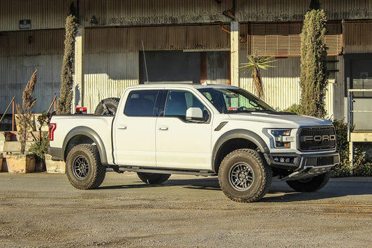 White pickup truck equipped with Enkei wheels for car camping and outdoor adventures
